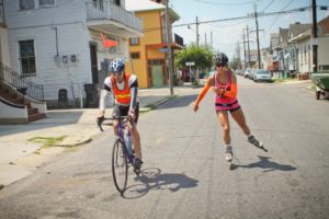 Kacie Fischer, inline skater in New Orleans, and Kevin Crossman, biker-helper