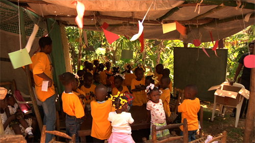 Rose-Marie Chierici and H.O.P.E.'s new mobile classroom/Borgne, Haiti--Photo: Martina Rawdan