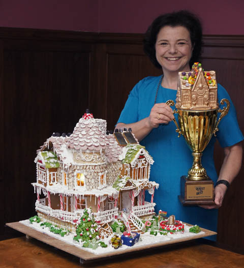 Laura Morrissette with her award-winning eco-friendly gingerbread house and her trophy