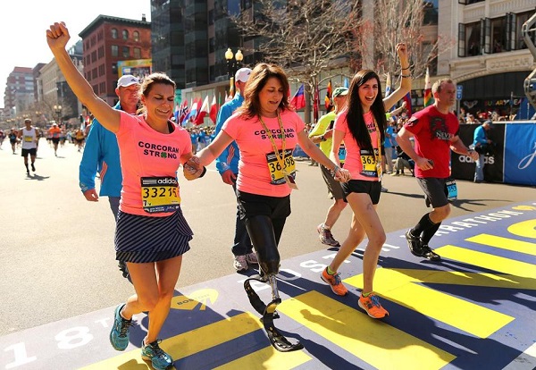 Corcoran family crosses Boston Marathon finish line/2014/Boston Globe