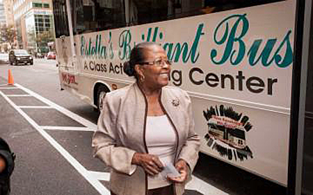 Estella Pyfrom standing in front of her Brilliant Bus, bridging the digital divide by bringing computer access to underserved communities | Photo: Christopher Bivens