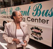 Estella Pyfrom standing in front of her Brilliant Bus mobile computer training center