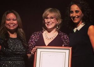 Tech Journalist Andrea Smith winning Lwegacy Award at 2015 CES Show flanked by michelle Troupe and Deena Ghazarian