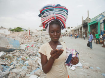 Kettelne Pierre, high school student in Haiti with cellphone/Natasha Fellien/Bill & Melinda Gates FOundation