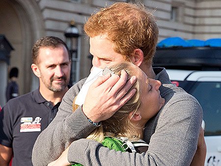 Prince Harry Embraces Wounded Warrior Kristie Ennis/Photo: People