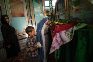 Woman at shrine in Afghanistan/Photo: Lynsey Addario for The New York Times