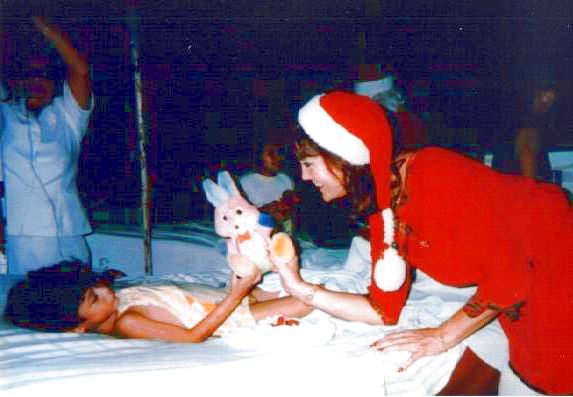 Nancy delivering present to a child in Bolivia