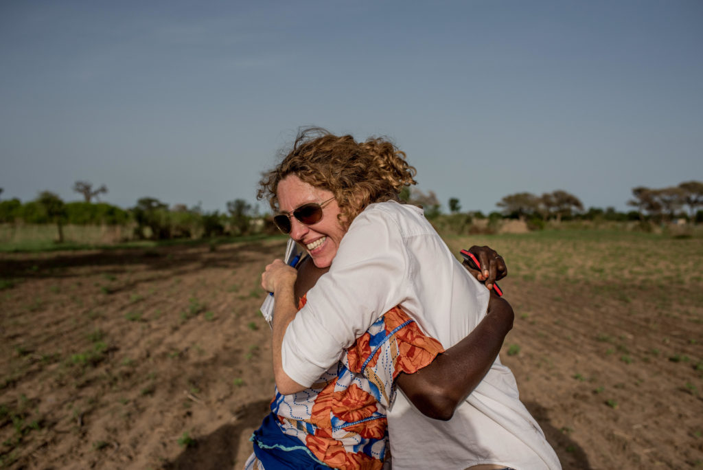 Dionne Searcey with Selbe in Senegal in baobab field harvesting leaves | Photo: Tomas Munita