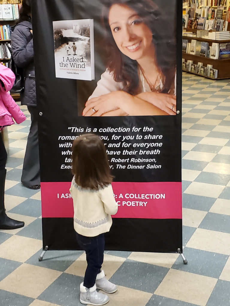 Debut author Valerie Nifora's niece George gazing at her photo at The Book Revue bookstore on Long Island/Photo: Betty Fobare
