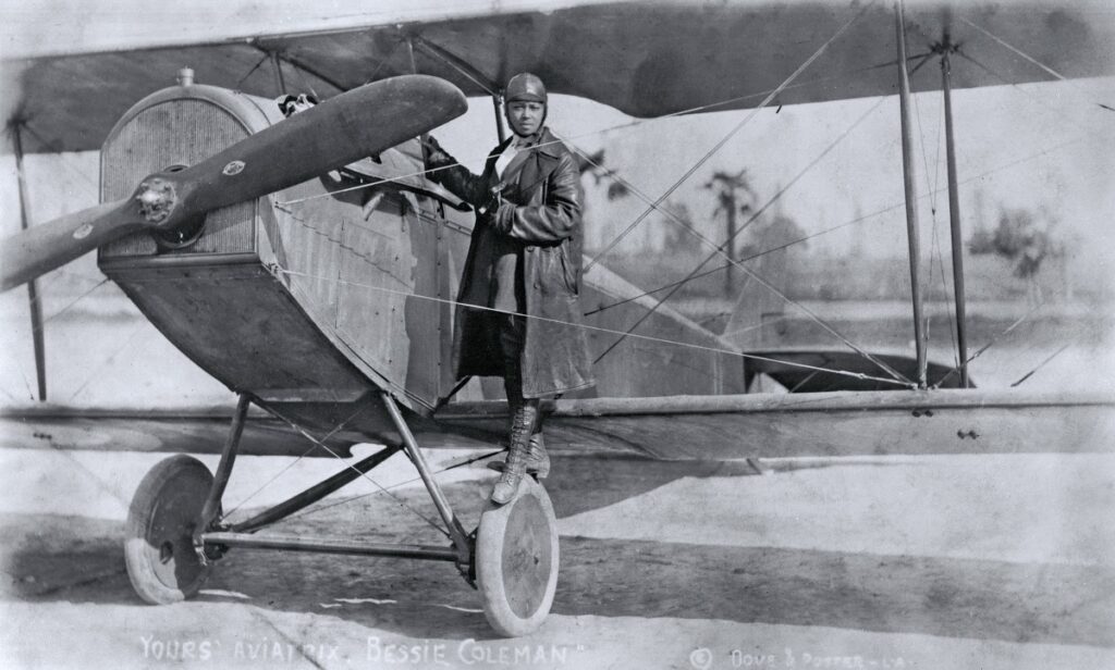 Bessie Coleman on the wheel of a Curtiss JN-4 "Jennie" in her flying suit, c. 1924/Photo: Smithsonian's National Air and Space Museum