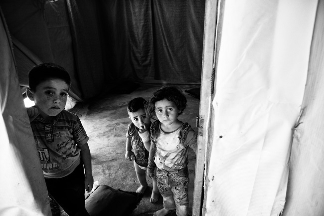 By the Tent Doors photo by Mimo Khair in her book Facing Future: Portraits of Resilient Children