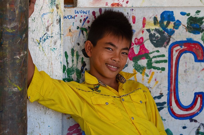 Boy in Yellow Shirt photo by Mimo Khair from her book Facing Future: Portraits of Resilient Children
